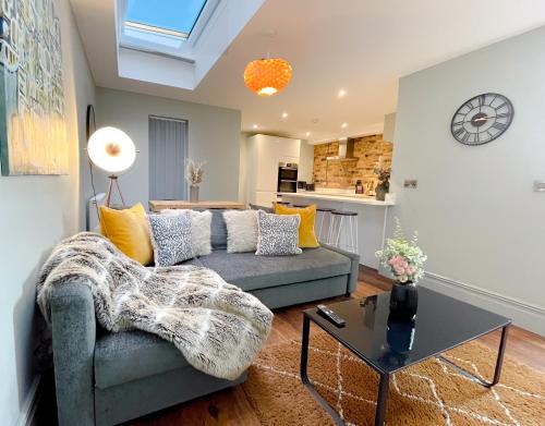 a living room with a couch and a table at Stunning Brighton Seaside 2-Bedroom Townhouse with Patio, Sleeps 6 in Brighton & Hove