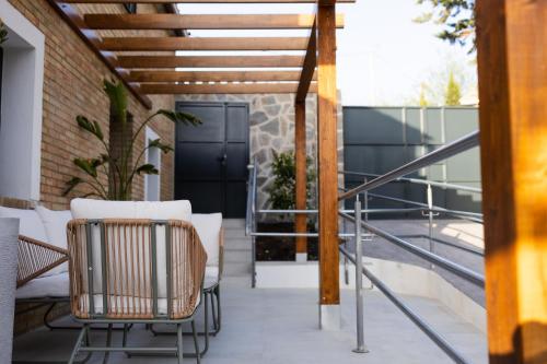 an outdoor patio with chairs and a railing at Cazorla Estelar in Cazorla