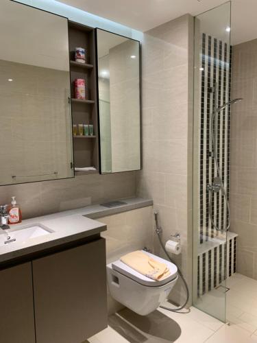 a bathroom with a toilet and a sink and a shower at Eaton Residences By Classic in Kuala Lumpur