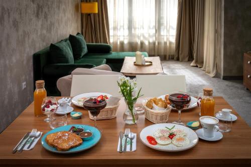 a table with plates of food on top of it at Snezhanka Hotel Pamporovo-All inclusive & Half Board in Pamporovo
