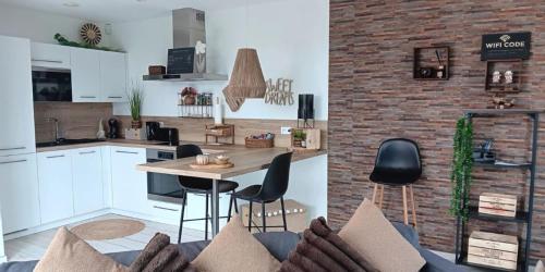 a kitchen and living room with a table and chairs at Sweet Dreams in Visé