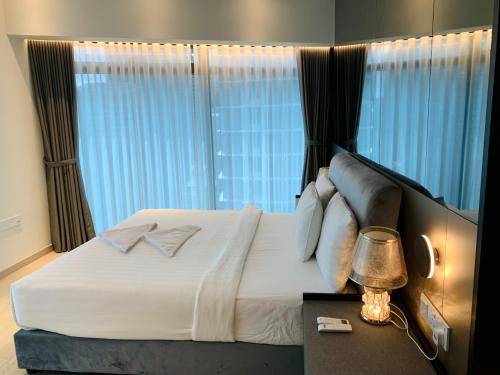 a bedroom with a bed with a large window at Eaton Residences By Classic in Kuala Lumpur