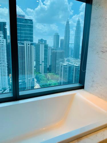 a window with a view of a city skyline at Eaton Residences By Classic in Kuala Lumpur