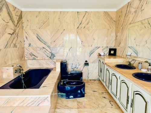 a bathroom with two sinks and a blue toilet at Global Immo 8010 Montclar in Roses
