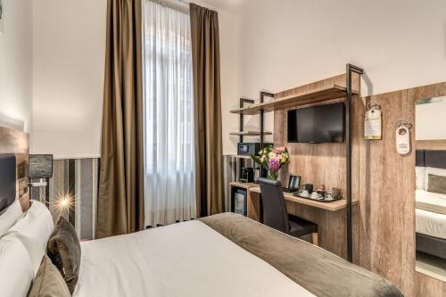a hotel room with a bed and a desk at Hotel Ottaviano Augusto in Rome