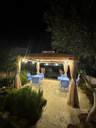 a group of tables and chairs under a tent at Mayfair Apartment Ksamil in Ksamil