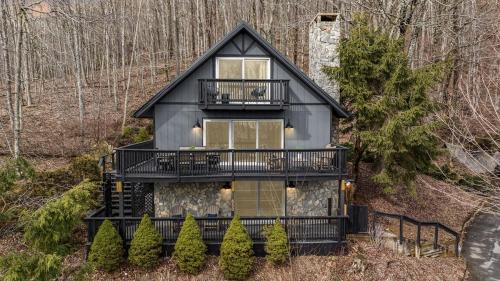 a house with a black roof and a balcony at Mtn Views, Game Room, Pet Friendly! in Seven Devils