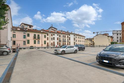 a parking lot with cars parked in front of buildings at MAISON MARIA city center Public Parking Available in Vicenza