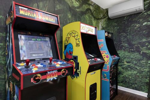 two arcade games next to each other in a room at Mtn Views, Game Room, Pet Friendly! in Seven Devils
