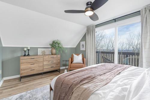 a bedroom with a bed and a dresser and a window at Mtn Views, Game Room, Pet Friendly! in Seven Devils