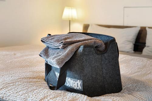 a bag of clothes is sitting on a bed at Haus Am Sonnenhügel in Bad Urach