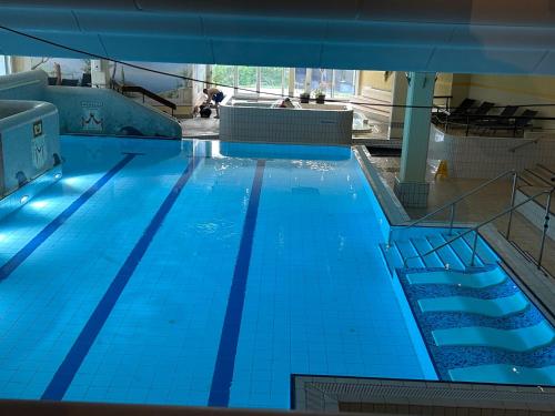 a large swimming pool with blue water at Ferienwohnung Predigtstuhl Resort in Sankt Englmar