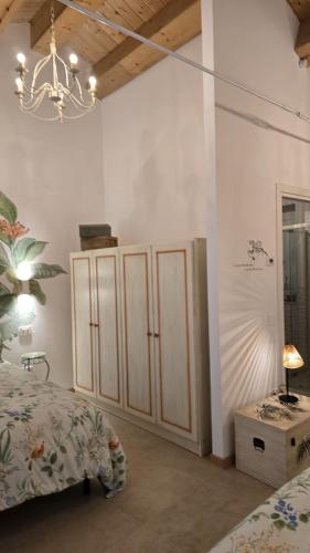 a bedroom with two beds and a chandelier at A casa di Matilde in Montegiorgio