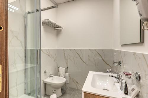 a bathroom with a sink and a shower and a toilet at Hotel Ottaviano Augusto in Rome