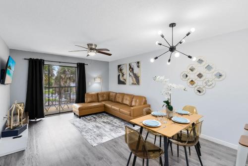 a living room with a couch and a table at Oasis 316 - Palm Paradise in Titusville