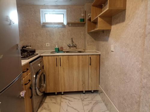 a kitchen with a sink and a washing machine at Квартира in Ganja