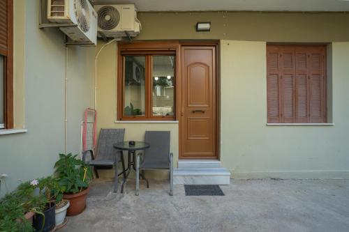 a door and a table in front of a house at N&M Apartment in Chios