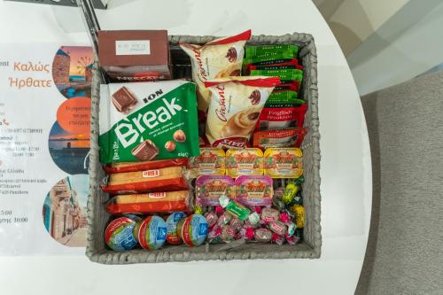 a basket filled with food and snacks on a table at N&M Apartment in Chios
