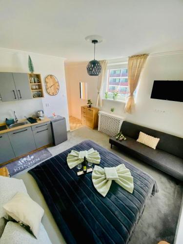 a room with a large bed with bows on it at Apartmán DEJA VÚ - Tatranská Štrba in Štrba