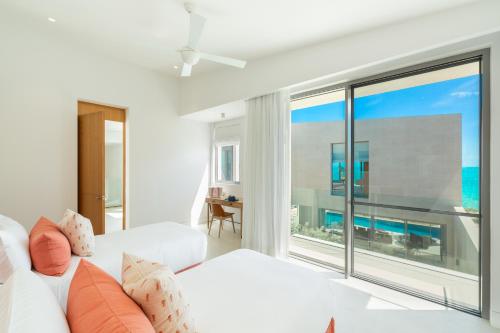 a living room with a white couch and a large window at South Bank in Long Bay Hills