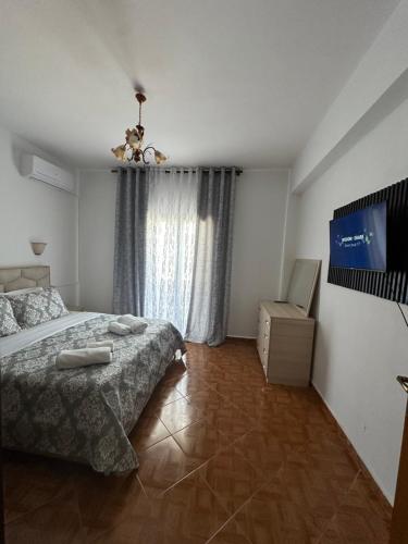 a bedroom with a bed and a television in it at Mayfair Apartment Ksamil in Ksamil