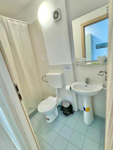 a bathroom with a toilet and a sink at Hotel Diana in Eforie Nord