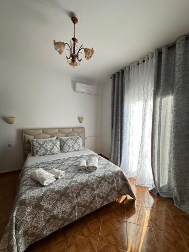 a bedroom with a bed with two towels on it at Mayfair Apartment Ksamil in Ksamil