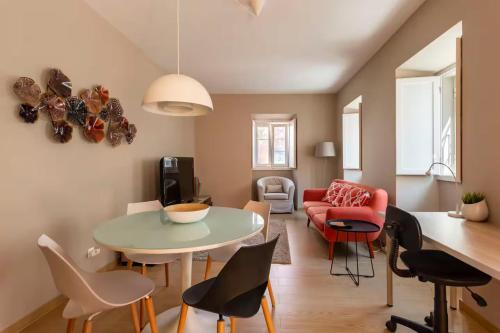 a living room with a table and chairs at Tower of Belém Premium Apartments A, B & C in Lisbon