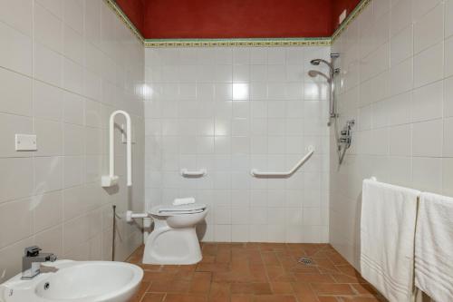 a white bathroom with a toilet and a sink at Chianti Classico Wine Resort Tenuta di Bibbiano - I Sodi in Castellina in Chianti