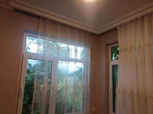 a room with a window with curtains at Квартира in Ganja