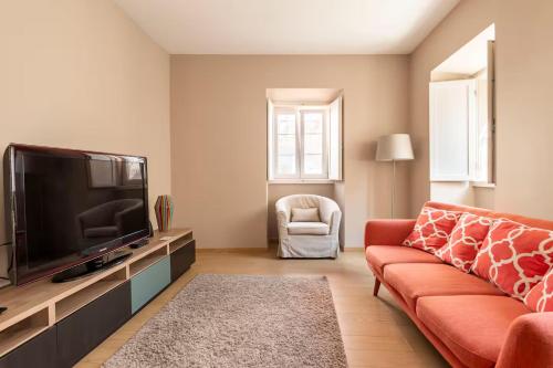 a living room with a couch and a flat screen tv at Tower of Belém Premium Apartments A, B & C in Lisbon