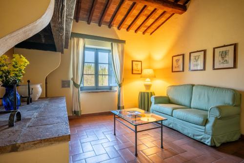 a living room with a couch and a table at Chianti Classico Wine Resort Tenuta di Bibbiano - I Sodi in Castellina in Chianti