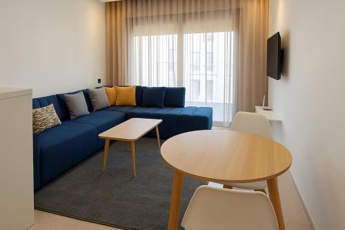 a living room with a blue couch and a table at New studio - Maarif Casablanca in Casablanca