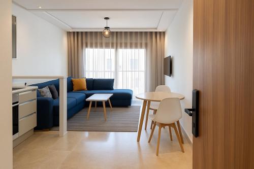 a living room with a blue couch and a table at New studio - Maarif Casablanca in Casablanca