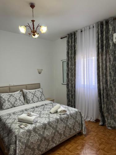 a bedroom with a bed with two towels on it at Mayfair Apartment Ksamil in Ksamil