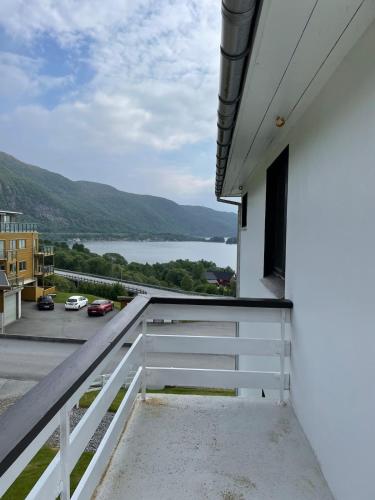 a balcony with a view of the water at Retro hus med fin beliggenhet in Haddal
