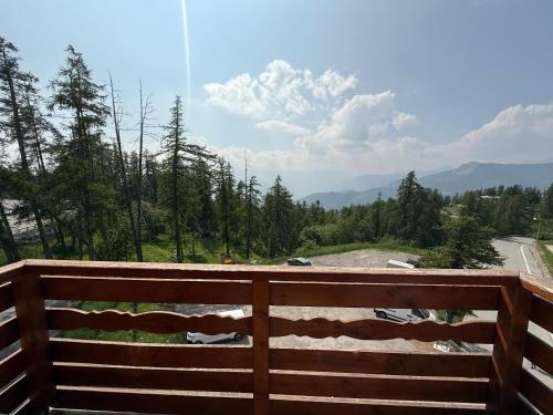 a wooden fence with a view of a road at Valberg - Appartement 6 pers au pied des pistes in Valberg