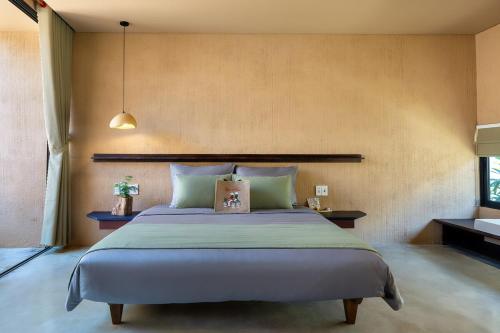 a bedroom with a large bed in a room at Qvilla Breeze, An Bang beach in An Bang