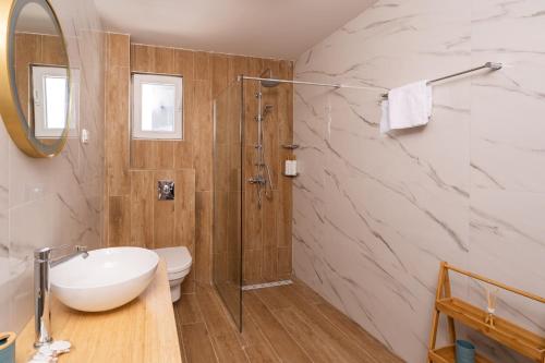 a bathroom with a sink and a toilet and a shower at Villa Leona in Dubrovnik