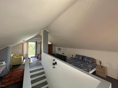 an attic bedroom with a bed and a staircase at Holiday house Sarajevo 