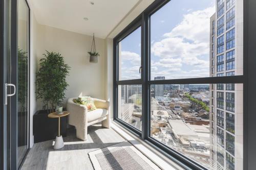 a living room with a window view of a city at Stunning Premium 2 Bed Flat with Great Views - Rooftop on Top Floor in Croydon