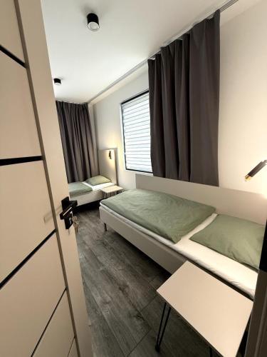 a room with two beds and a window at Nyrenoverat lägenhet i Halmstad in Halmstad