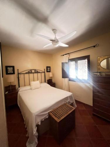 a bedroom with a bed and a ceiling fan at Casa Martijo in Taramay
