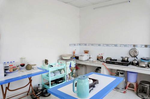 a kitchen with a blue table in a room at Jolilian Bãi Sau in Vung Tau