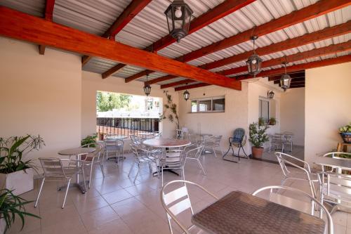 a patio with tables and chairs in a building at Los Robles in Villa Cura Brochero
