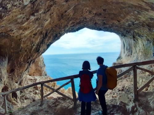 a couple standing in front of a cave at Villaggio Turistico Tecciù di Cuppi in Magliolo
