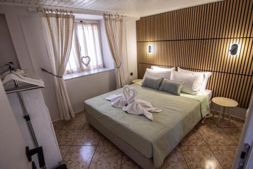 a bedroom with a bed with a towel on it at Nonna Konstantina- old town center in Lefkada