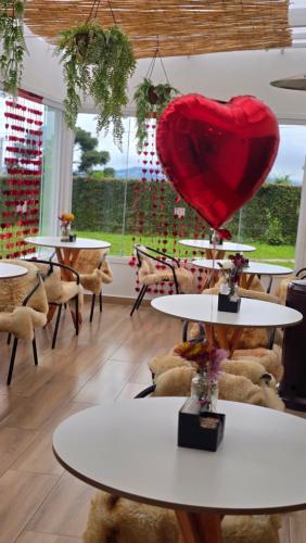 a heart sitting on top of tables in a room at Pousada Villa Dolce Amore - Boutique Hotel in Campos do Jordão