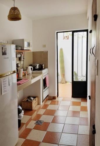 a kitchen with a refrigerator and a tile floor at Kamay Apart Cafayate in Cafayate