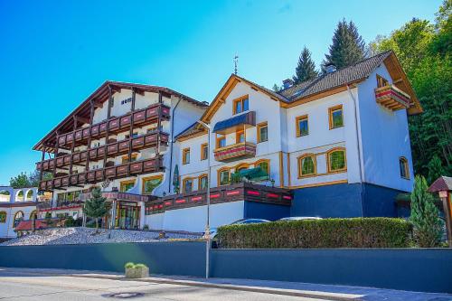 a large white building with a blue at Holzschuhs Schwarzwaldhotel in Baiersbronn